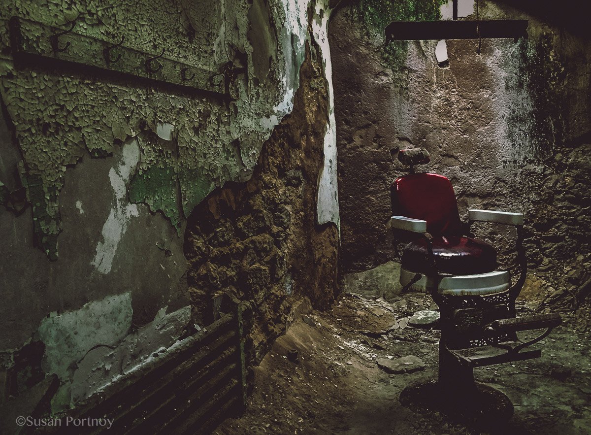 An old barber chair in a cell in Eastern State Penitentiary